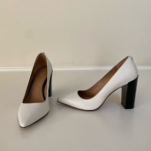 Like New. Calvin Klein, size 8. Soft white pump with black patent heel.